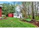 Well-maintained sheds surrounded by lush landscaping in the home's backyard at 1630 N 400 W, Bargersville, IN 46106