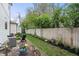 Lush backyard with a patio, flower bed and wooden fence at 2044 Alvord St, Indianapolis, IN 46202