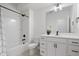 Bright bathroom featuring a shower-tub combo and vanity with modern black fixtures at 2044 Alvord St, Indianapolis, IN 46202