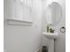Chic powder room featuring pedestal sink, stylish faucet, and bright natural lighting at 2044 Alvord St, Indianapolis, IN 46202