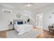 Modern bedroom with neutral tones, hardwood floors, stylish bedside tables, and ensuite bathroom access at 2044 Alvord St, Indianapolis, IN 46202