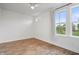 Bright bedroom featuring hardwood floors, a modern ceiling fan, and a large window for natural light at 2044 Alvord St, Indianapolis, IN 46202