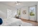 Well-lit bedroom boasts hardwood floors, ample windows, and neutral tones at 2044 Alvord St, Indianapolis, IN 46202