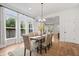 Dining area with large windows, stylish table setting, modern light fixture, and neutral color palette at 2044 Alvord St, Indianapolis, IN 46202