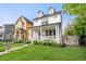 Charming white two-story home boasts a welcoming front porch and manicured lawn at 2044 Alvord St, Indianapolis, IN 46202