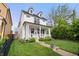 Inviting white two-story home features a classic design and well-maintained landscaping at 2044 Alvord St, Indianapolis, IN 46202