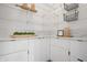 Well-organized pantry with white cabinets, marble backsplash, and ample shelving space at 2044 Alvord St, Indianapolis, IN 46202