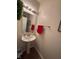 Clean half bath featuring a pedestal sink and a decorative mirror at 2068 Deer Valley Ct, Columbus, IN 47201