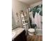 Bathroom featuring a toilet, shower curtain, decorative shelf, and modern design at 2068 Deer Valley Ct, Columbus, IN 47201