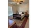 Cozy bedroom with a dark wood frame bed, soft rug, and a window providing natural light at 2068 Deer Valley Ct, Columbus, IN 47201