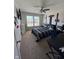 Cozy bedroom featuring a ceiling fan, carpet, and natural light from the windows at 2068 Deer Valley Ct, Columbus, IN 47201