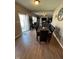 Dining area with a dark wood table and seating, connecting to a living space with natural light at 2068 Deer Valley Ct, Columbus, IN 47201