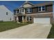 Charming two-story home with a brick and siding exterior and a well-maintained front yard at 2068 Deer Valley Ct, Columbus, IN 47201