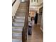 Hallway featuring hardwood floors and staircase, leading to other areas of the home at 2068 Deer Valley Ct, Columbus, IN 47201