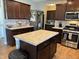 Spacious kitchen showcasing a center island, stainless steel appliances, and dark wooden cabinets at 2068 Deer Valley Ct, Columbus, IN 47201