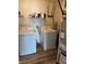 Functional laundry room with washer, dryer, and storage shelving at 2068 Deer Valley Ct, Columbus, IN 47201