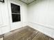 Cozy back porch with a glass panel door providing natural light and access to the outdoors at 223 E 53Rd St, Anderson, IN 46013