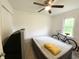 Bright bedroom featuring a ceiling fan, natural light, and an air mattress for flexible sleeping arrangements at 223 E 53Rd St, Anderson, IN 46013