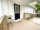 Inviting covered front porch with seating area and ramp provides accessible entry at 223 E 53Rd St, Anderson, IN 46013