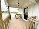Inviting covered front porch with seating area and ramp provides accessible entry at 223 E 53Rd St, Anderson, IN 46013