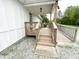 Welcoming front porch with wooden railings and ramp provides accessible entry to the home at 223 E 53Rd St, Anderson, IN 46013