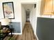 Bright hallway featuring hardwood floors and decorative wall art leading to other rooms in the house at 223 E 53Rd St, Anderson, IN 46013