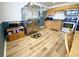 Well-lit kitchen featuring stainless steel appliances, wood cabinets, and new laminate flooring at 223 E 53Rd St, Anderson, IN 46013