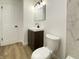 Bathroom featuring a dark vanity, framed mirror and tile accent wall at 3019 Knobstone Ln, Indianapolis, IN 46203