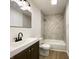 Modern bathroom with dark vanity, a framed mirror, and tiled shower at 3019 Knobstone Ln, Indianapolis, IN 46203