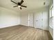 Bedroom featuring wood-look floors, white walls, and a ceiling fan at 3019 Knobstone Ln, Indianapolis, IN 46203