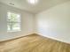 Bedroom with wood-look floors and a window bringing in natural light at 3019 Knobstone Ln, Indianapolis, IN 46203
