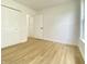 Bright bedroom featuring wood-look floors and double door closets at 3019 Knobstone Ln, Indianapolis, IN 46203