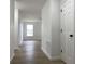 Bright hallway featuring wood-look floors and white doors leading to various rooms at 3019 Knobstone Ln, Indianapolis, IN 46203