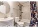 Well-lit bathroom with round mirror, white sink, toilet, and bathtub with decorative shower curtain at 328 N Layman Ave, Indianapolis, IN 46219