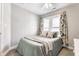 Neutral bedroom with carpet, a bed with soft pillows, and a large window at 328 N Layman Ave, Indianapolis, IN 46219