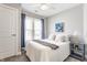 Bedroom featuring neutral walls, carpet, a ceiling fan and a large double window at 328 N Layman Ave, Indianapolis, IN 46219