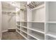 This roomy walk-in closet includes shelving, rod space and a bench at 328 N Layman Ave, Indianapolis, IN 46219