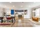 Open dining room with hardwood floors, opening to bright kitchen and living spaces at 328 N Layman Ave, Indianapolis, IN 46219