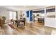 Open dining room with hardwood floors and bright kitchen in background at 328 N Layman Ave, Indianapolis, IN 46219
