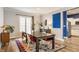 Bright dining room features a rustic wood table, modern chairs, and a colorful rug at 328 N Layman Ave, Indianapolis, IN 46219