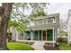Charming two-story home with a inviting front porch and second floor balcony at 328 N Layman Ave, Indianapolis, IN 46219