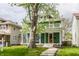 Inviting two-story home featuring a spacious front porch and mature trees at 328 N Layman Ave, Indianapolis, IN 46219