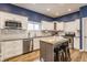 Stylish kitchen with white cabinetry, granite countertops, and a functional center island at 328 N Layman Ave, Indianapolis, IN 46219