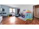 Spacious bedroom with wood floors, natural light, and an attached bathroom for added convenience at 335 N Franklin Rd, Indianapolis, IN 46219