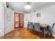 Charming dining room with hardwood floors, ornate french doors, and a classic built-in cabinet at 335 N Franklin Rd, Indianapolis, IN 46219