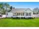 Charming single-story home with lush green lawn and white siding, showcasing its inviting curb appeal at 335 N Franklin Rd, Indianapolis, IN 46219