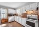 Bright kitchen features white cabinetry, modern appliances, and natural light, creating a functional space at 335 N Franklin Rd, Indianapolis, IN 46219
