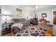 Comfortable living area featuring a plush sectional, recliner, hardwood flooring, and stylish accents at 335 N Franklin Rd, Indianapolis, IN 46219