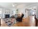 Inviting living room with a cozy fireplace, comfortable seating, and warm hardwood floors at 335 N Franklin Rd, Indianapolis, IN 46219