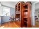 Cozy office space with a built-in bookcase, a comfortable chair, and natural light from the window at 335 N Franklin Rd, Indianapolis, IN 46219